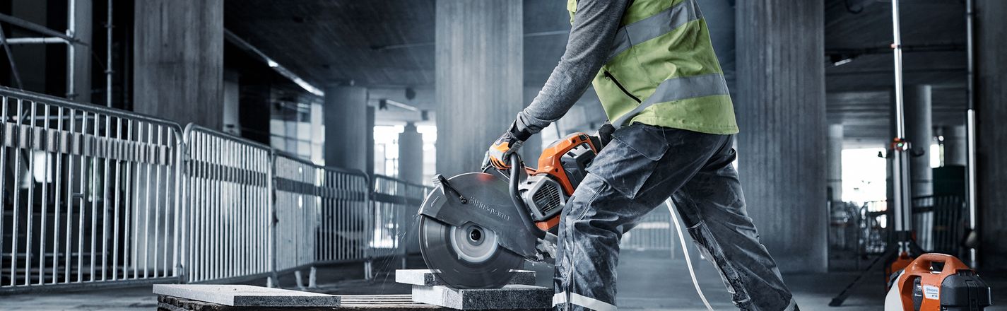 Husqvarna power cutter being used to cut concrete pavers on jobsite